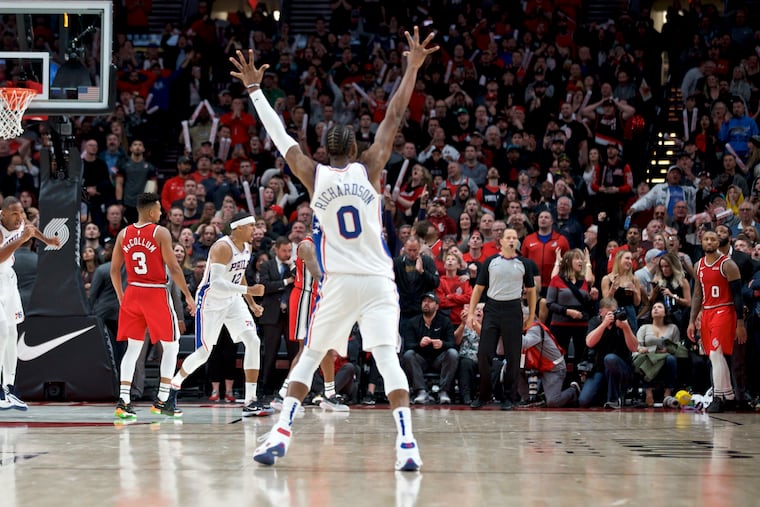 76ers forward Al Horford (left), forward Tobias Harris (12) and guard Josh Richardson (0) react with joy after guard Furkan Korkmaz (right, on the floor) made the game-winning three-point basket against the Portland Trail Blazers.