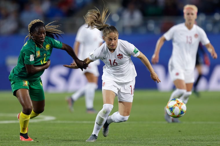 Canada's Janine Beckie, right, and Cameroon's Claudine Meffometou battle for the ball.