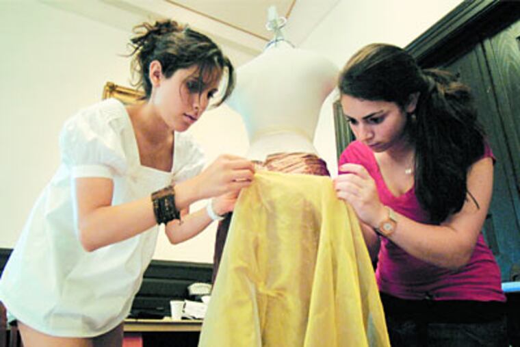 Lorena Marquez and Ariello Saragossi (right) assemble a dress in a fashion class at a Julian Krinsky camp at Haverford College. (Jonathan Wilson/Inquirer)