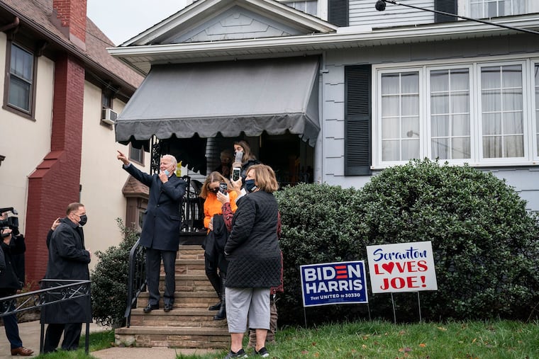 Democratic presidential nominee Joe Biden waves to onlookers from the steps of his childhood home on November 3, 2020, in Scranton, Pennsylvania.