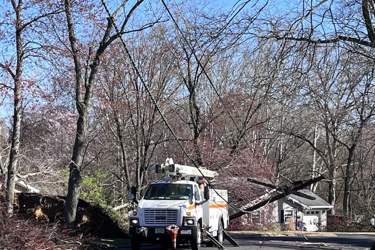 A crew from PSE&G work to restore power along Buttonwood Lane in Cinnaminson, Burlington County, N.J., Sunday morning, April 2, 2023. The National Weather Service is investigating a tornado that possibly struck the town April 1, as well as in neighboring Delran.