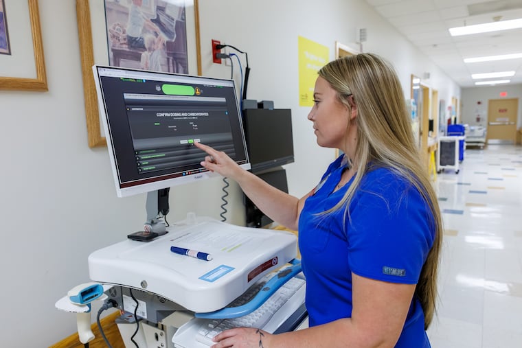 Bella Pollozi, a Temple University Hospital nurse demonstrates how to use EndoTool, an AI program that helps monitor blood sugar levels among patients with diabetes and make custom insulin dose recommendations.
