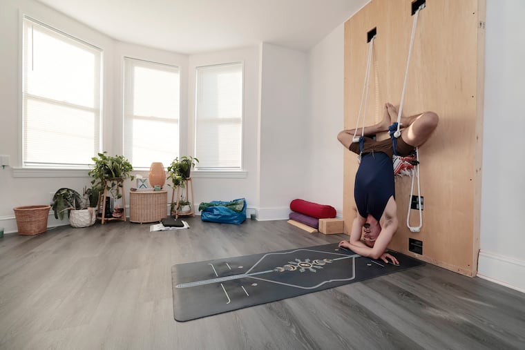 Foglesong uses the rope wall to work out in the studio of his home.