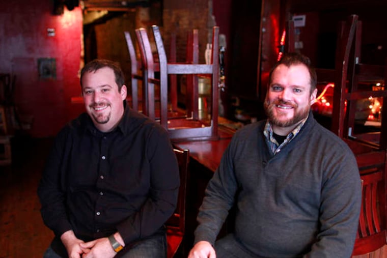 Joe Lekkas (left) and Mike Snyder upstairs at Khyber Pass Pub, where the Freelancers Holiday Ball will be held. Both self- employed, they decided to throw an office party for others who are 'office-party orphans.' ( DAVID SWANSON / Staff Photographer )