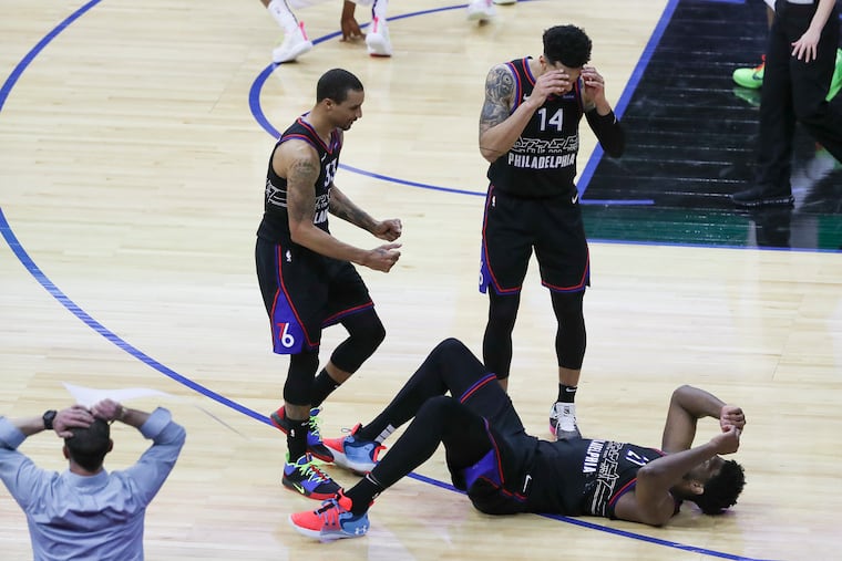 The Sixers' veteran leaders, including George Hill (left) and Danny Green (14), have been good for Joel Embiid (on his back) and the rest of the team.