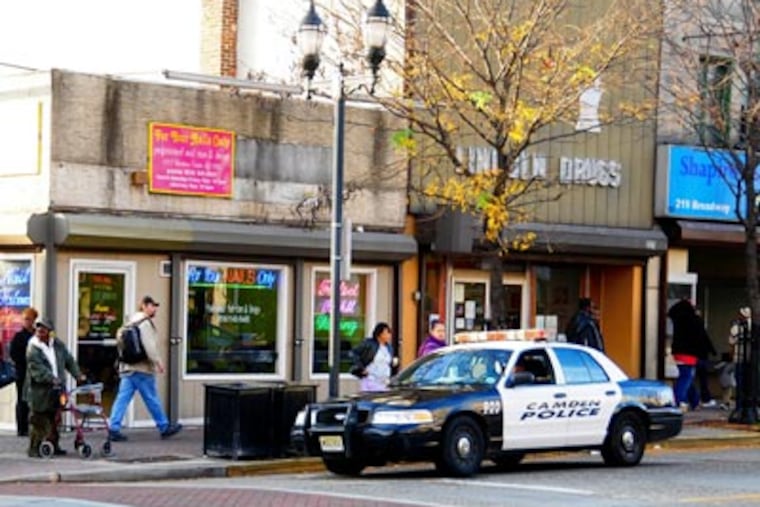 A patrol car surveys the streets at Broadway and Mickle Blvd. in Camden. ( Jason Melcher / Staff Photographer )