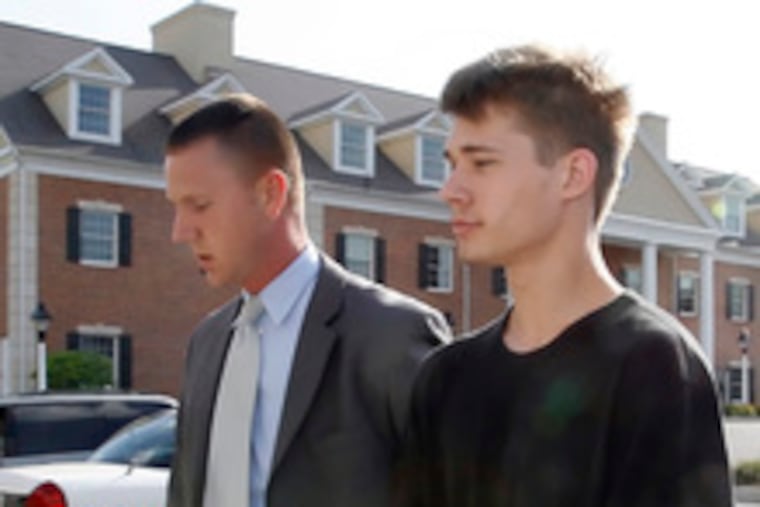 Alec Devon Kreider, 16, is escorted to his arraignment by Manheim Township police.