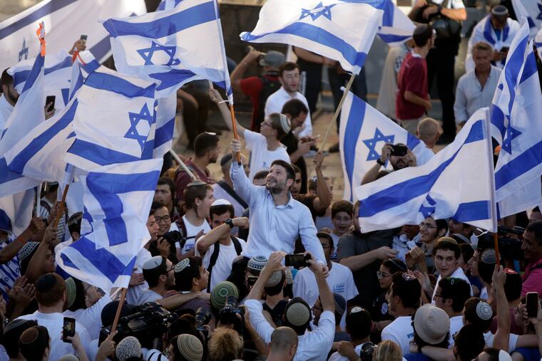 Israeli Knesset member Bezalel Smotrich (center) waved an Israeli flag together with other Jewish ultranationalists during the "Flags March" next to Damascus gate, outside Jerusalem's Old City, on Tuesday.
