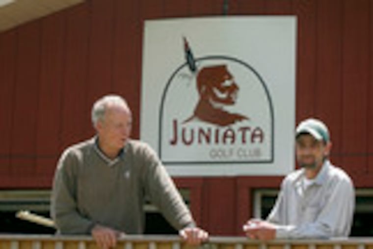 Paul Hicks (left) and Ron Henderson at the cart barn that has been converted into a clubhouse and banquet room.