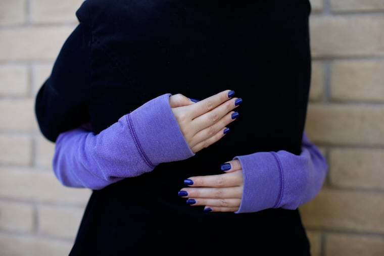 MJ embraces her adoptive mother, Nancy Salminen, in Sierra Vista, Ariz. State authorities placed MJ in foster care after learning that her father, the late Paul Adams, sexually assaulted her and posted video of the assaults on the internet.