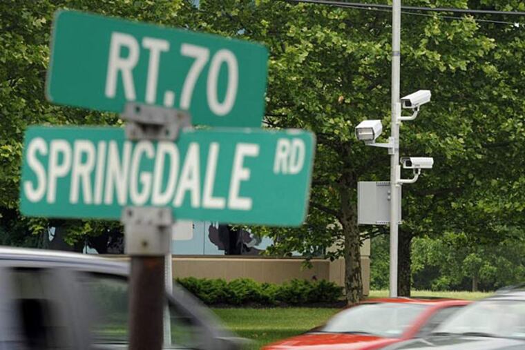 Red-light cameras (right) are mounted on eastbound Route 70, at Springdale Road in Cherry Hill. (Tom Gralish/File photo)