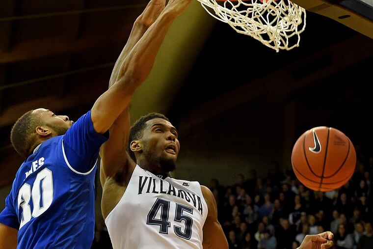 Villanova's Darryl Reynolds slam dunks a rebound against Seton Hall's Madison Jones.