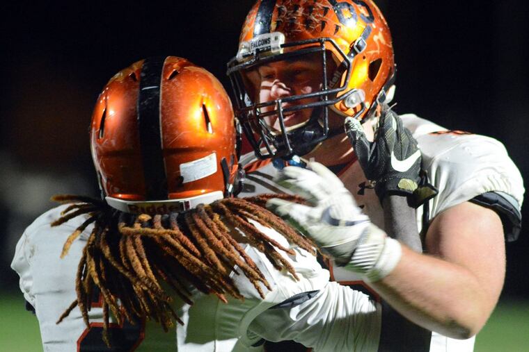 Pennsbury’s Nasan Robbins (left) and Nika Wright celebrate a touchdown against Neshaminy in the first quarter on Friday.