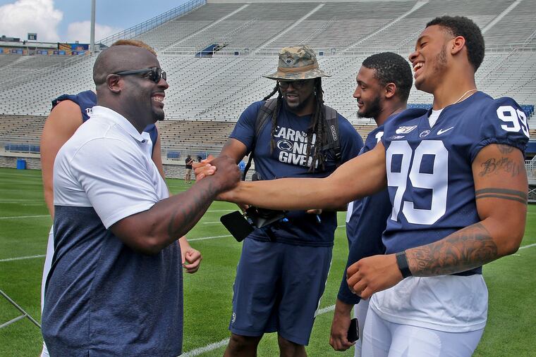 Penn State football defensive end Yetur Gross-Matos (99) jokes with associate head coach/defensive line coach Sean Spencer during the program's annual Media Day on Aug. 3, 2019. CRAIG HOUTZ / For the Inquirer