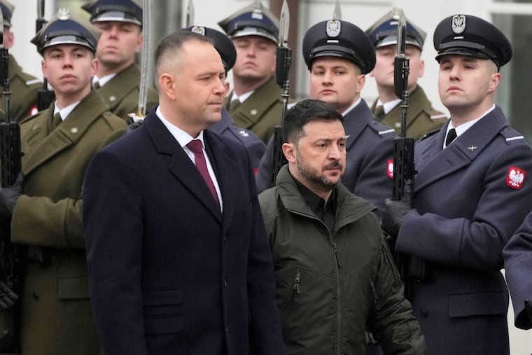 Polish President Karol Nawrocki, left, and Ukrainian President Volodymyr Zelensky attend an official welcome ceremony before their meeting at the Presidential Palace in Warsaw, Poland, Dec. 19, 2025.