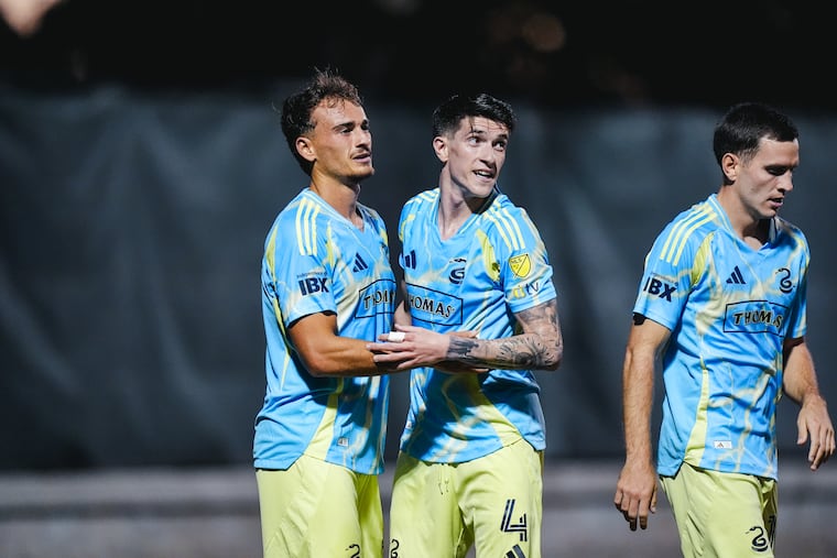 Agustín Anello (left) celebrates with Jovan Lukić (center) after assisting a goal in the Philadelphia Union's preseason game against CF Montréal.