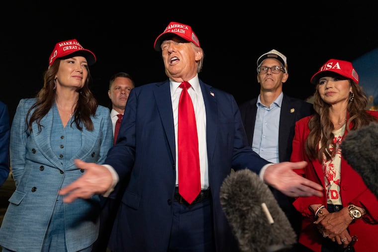 President Donald Trump, center, speaks with reporters as, from left, Agriculture Secretary Brooke Rollins, Rep. Zachary Nunn, R-Iowa, Rep. Randy Feenstra, R-Iowa, and Homeland Security Secretary Kristi Noem listen as they arrive on Air Force One, Friday, July 4, 2025, at Joint Base Andrews, Md.