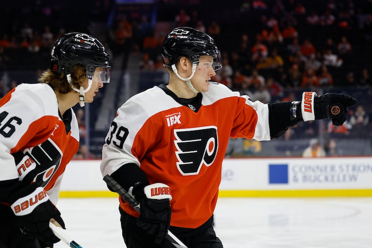 Flyers right wing Matvei Michkov directs center Trevor Zegras against the Nashville Predators on Thursday.