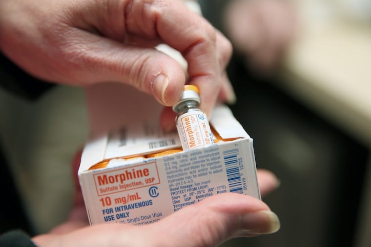 Donna Curry, manager for VNA Philadelphia inpatient unit, displays a vial of morphine at its facility in Philadelphia on Tuesday.