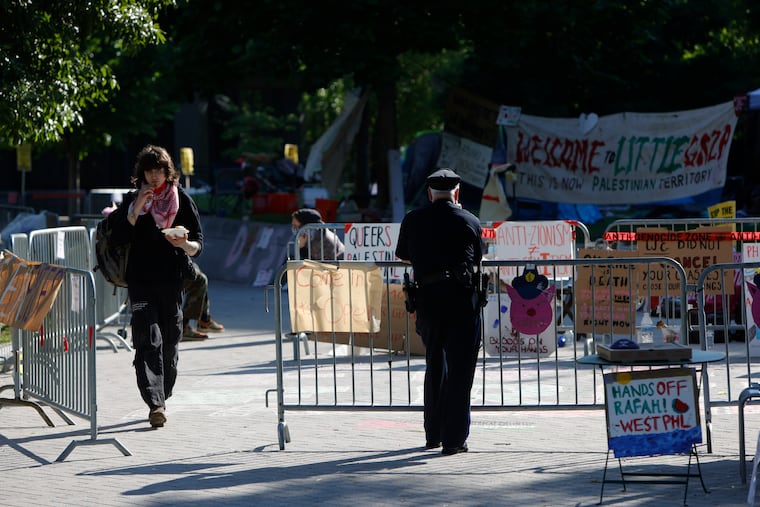 A police officer watches the encampment at Drexel University Wednesday.