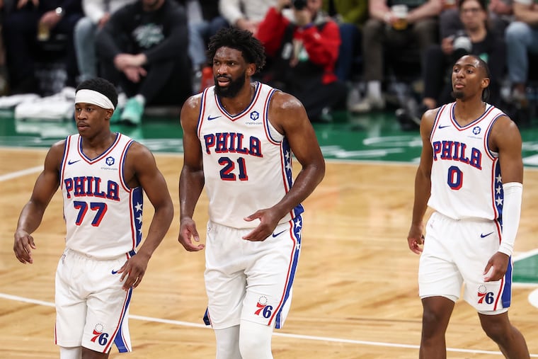 From left, Sixers guard VJ Edgecombe, Joel Embiid and guard Tyrese Maxey stand together during their Game 7 defeat against Boston in Boston earlier this month.