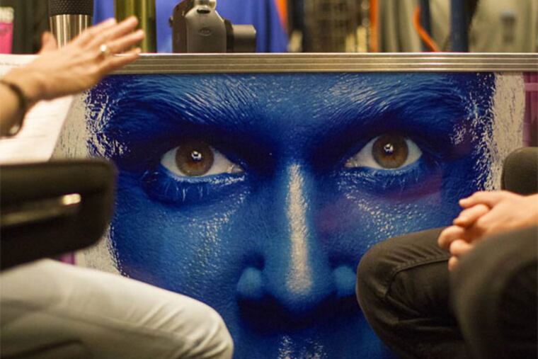 In this July 9, 2013 photograph, Rachel Schripsema, left, interviews Blue Man Group hopeful Ian McCabe during a casting call at the Briar Street Theatre in Chicago. Blue Man Group, which started with three friends in New York more than two decades ago, has grown from an off-Broadway show to also have productions in Boston, Chicago, Las Vegas and Orlando, Fla. A tour will soon take the blue men to stops in cities like Atlantic City, N.J.; Durham, N.C.; Lincoln, Neb.; Corpus Christi, Texas; Portland, Maine; and Kennewick, Wash. (AP Photo/Scott Eisen)