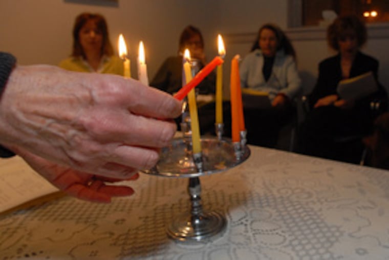 "People are really fragile around this time," says Rabbi Tsurah August, lighting a candle for a "Lightsin the Darkness" program at the Joan Grossman Center for Chaplaincy and Healing in Elkins Park.