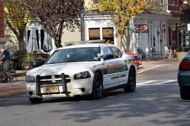 A Bordentown Township Police patrol car rides along Farnsworth Avenue in Bordentown City shortly after the hate crime charges were announced against former Chief Frank Nucera Jr.