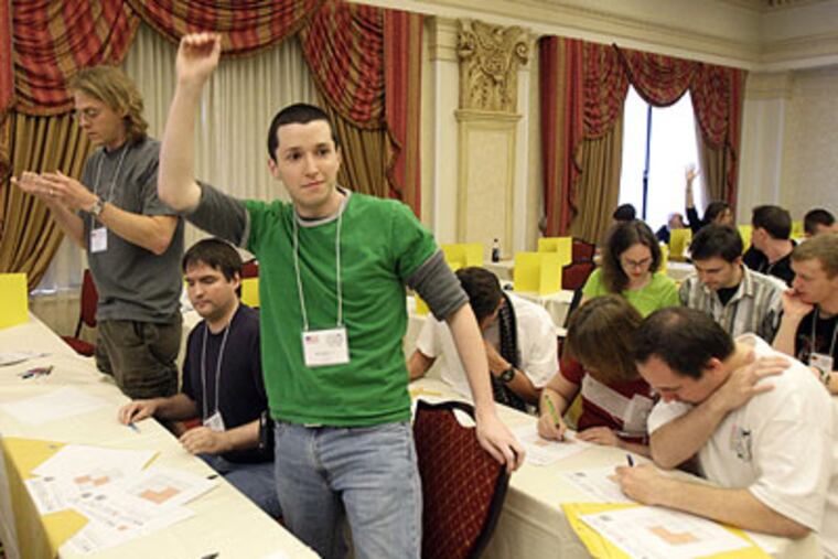 (From left to right) Jim Schneider of Kankakee, Il, Jonathan Rivet of Wheaton, Il and William Blatt of Atlanta, are Team B for the USA and were the winners of the first round of team competition. Here, Blatt pops up and yells finished during the Inquirer-sponsored World Sudoku Championship at the Courtyard Marriott in Philadelphia on Friday. (Elizabeth Robertson / Staff Photographer)