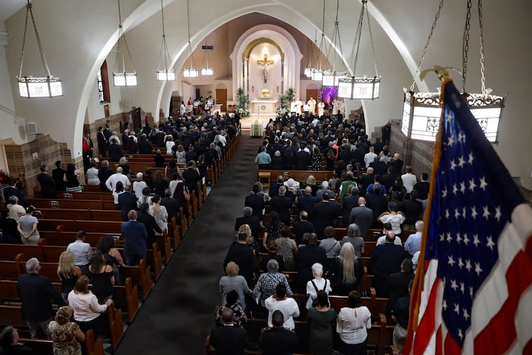 Mourners stand during the funeral Mass for Detective Luis Alvarez, at Immaculate Conception Church, in the Queens borough of New York, Wednesday, July 3, 2019. Alvarez, 53, who died Saturday, June 29, 2019, after a three-year battle with colorectal cancer, fought until his final days for the extension of the Sept. 11 Victim Compensation Fund.