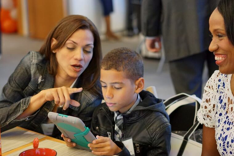 Delis Serrano-Estrada and son Derek use the internet.