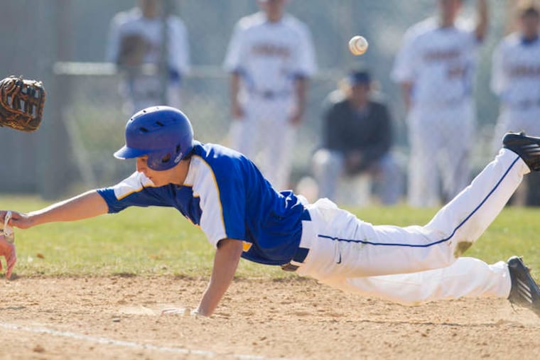 Downingtown West's Dalton Reed beats the throw to first baseman Eric Sigovich of Downingtown East. ED HILLE / Staff