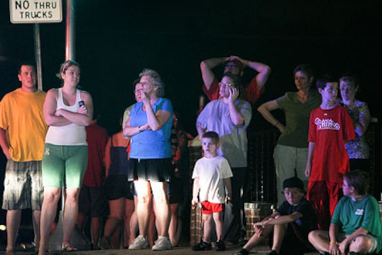 Neighbors gather after experiencing what was determined to be an earthquake in Northeast Philadelphia near Knights Road and Fairdale Road on Friday night. (Joseph Kaczmarek / For the Daily News)