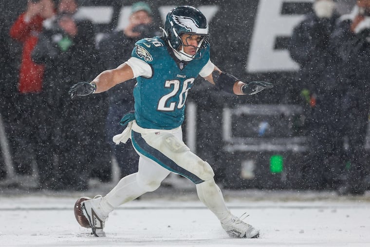 Eagles running back Saquon Barkley celebrates his fourth-quarter touchdown run against the Rams.