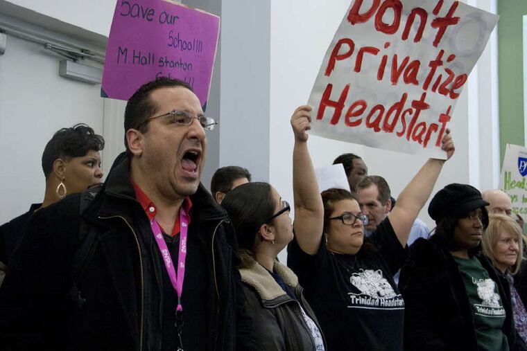 Teachers, students, and parents interrupt a meeting of the School Reform Commission to protest the district's plan to close 29 schools. The SRC is to vote on the plan March 7.