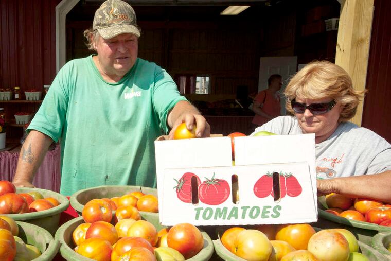 William and Mary Ellen DeHart at their West Deptford stand. The market, open since 1968, had to move - and ended up across the street.