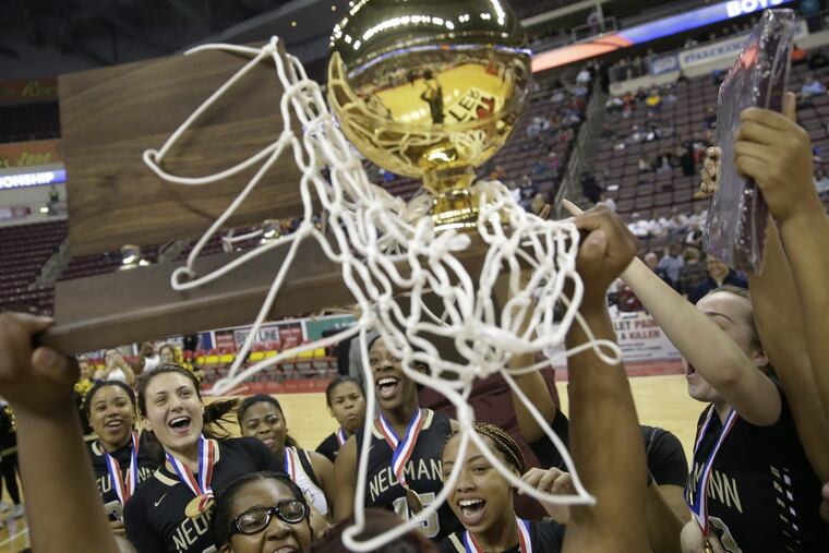The Neumann-Goretti players rejoice after capturing their fourth consecutive state basketball crown with a 63-46 defeat of Bishop Canevin.