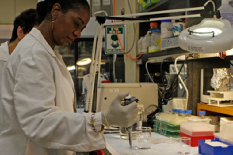 Walking a mile - or at least spending a day - in someone else's shoes, breast-cancer survivor Pat Andrews isolates RNA from frozen tissue in the Fox Chase Cancer Center's research lab. She was one of 11 women in a program designed to educate cancer survivors so they might be better advocates in the battle to conquer the disease.