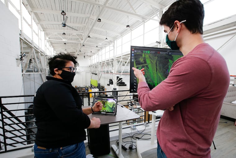 Robotics Software Engineer, Nour Hussein (left) and Director of R&D Software Brandon Duick of Exyn Technologies talk before a drone flight demonstration inside the company's South Philadelphia office on March 4, 2021. Exyn Technologies makes aerial autonomous drones and software for use by miners that collect data and images in difficult environments.