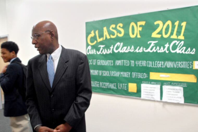 Boys' Latin Charter School chief David Hardy encourages freshman Hassan Brown. The school’s goal is to get more boys, particularly African American boys, into college. (Tom Gralish / Staff Photographer)