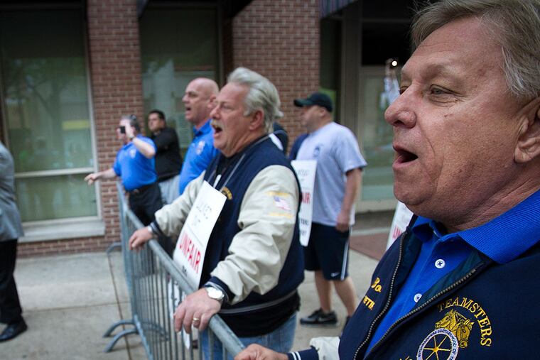Teamsters Local 107 yell as unionized labor enters the Pennsylvania Convention Center in center city Philadelphia. Teamsters Local 107 are protesting alleged lockout by management at the convention center on Monday morning May 12, 2014. ( ALEJANDRO A. ALVAREZ / STAFF PHOTOGRAPHER ) (AP Photo / The Philadelphia Daily News, Alejandro A. Alvarez )