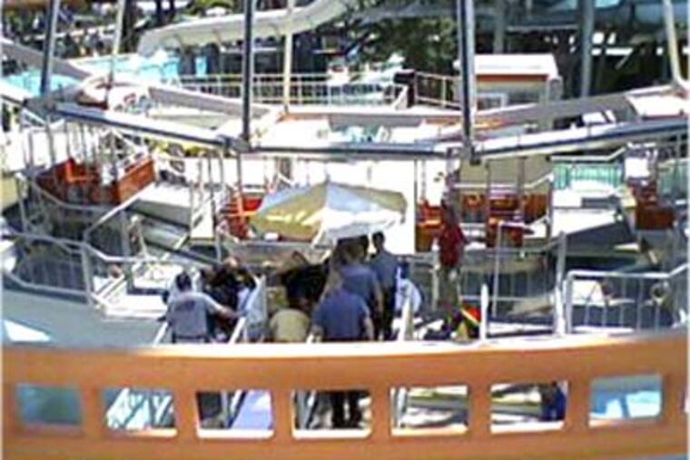 Medical personnel work on a young girl after she fell from a Ferris wheel at Morey's Pier on the boardwalk in Wildwood this afternoon. (Donnalee Landwher / For the Inquirer)