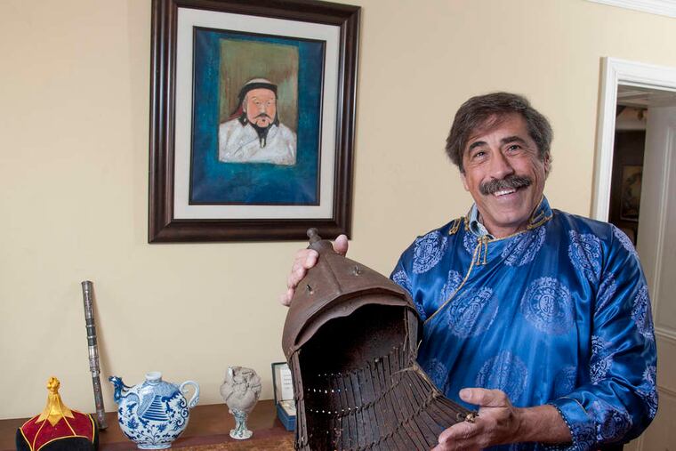Don Lessem, who helped organize "Genghis Khan: Bring the Legend to Life," with a 14th-century Mongolian helmet.