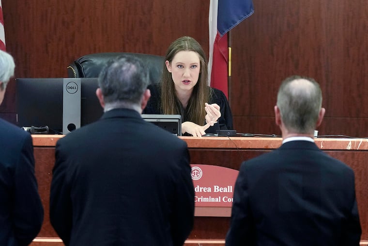 Defense and prosecution lawyers approach the bench of Judge Andrea Beall to discuss fraud charges, later dropped, against Texas Attorney General Ken Paxton in Houston in 2023. Civil argument is a cornerstone of American justice.