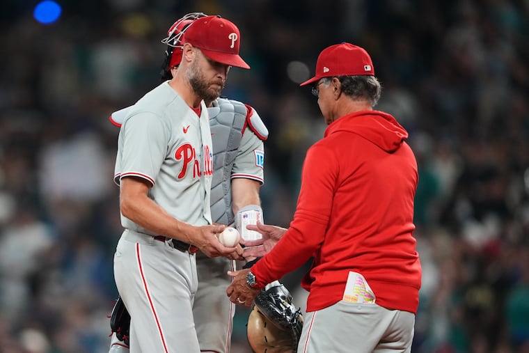 Phillies starting pitcher Zack Wheeler, left, was pulled in the fifth inning after giving up nine hits, eight runs and four home runs.