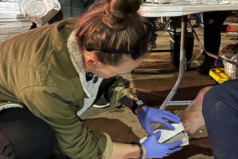 In Philadelphia's Kensington neighborhood, Stephanie Klipp, a wound care nurse, works to bandage a serious xylazine wound in danger of reaching this man's bone.