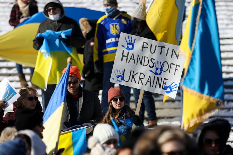 A sign reads "PUTIN HANDS OFF UKRAINE," as the local Ukranian community and supporters gathered for a rally on the Art Museum steps in Philadelphia on Sunday. People rallied in support of the Ukraine amid tensions over a threatened Russian invasion.