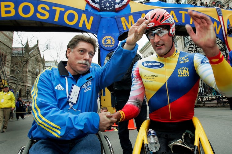 Ernst Van Dyk of South Africa (right) shakes hands with former wheelchair winner Bob Hall, after he won the men's wheelchair division of the 110th running of the Boston Marathon on April 17, 2006.