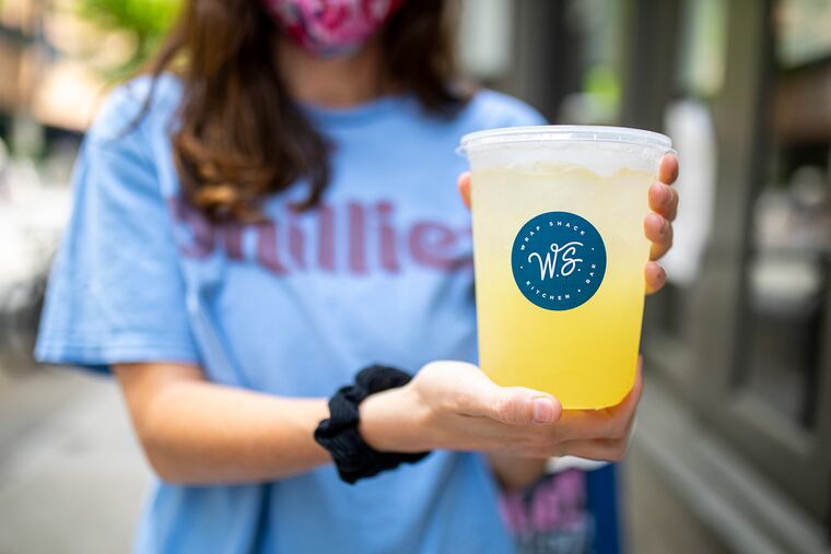 Kirsti Paolini, 28, of Fishtown, poses for a photo with a margarita she ordered for to-go from Wrap Shack on Wednesday, May 27, 2020.