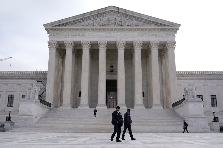 Police officers walk outside the Supreme Court on Capitol Hill in Washington, Tuesday, Feb. 28, 2023.